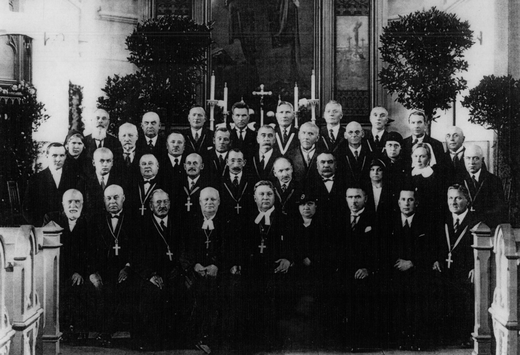 Peetri koguduse kirikuvanemad, õpetajad, koguduse eestseisjad ja Peetri kooli õpetajad. Tõenäoliselt sügisel 1939, koguduse 70. aastapäeval. Kirik on kaunistatud botaanikaaia omanik Herman Mülleri (sakslane) loorberi puudega. H. Müller ise paremal äärel alt kolmas